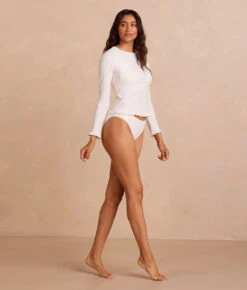 The Waterside Ruffle Rash Guard - White Sand 5 The Waterside Ruffle Rash Guard - White Sand -Cheap Sunset Bikini Store PDP WatersideRuffleRashGuard WhiteSand Front Full